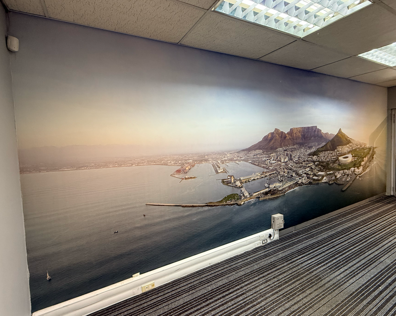 Completed seamless wallpaper installation featuring the Cape Town City Bowl in an office reception area.
