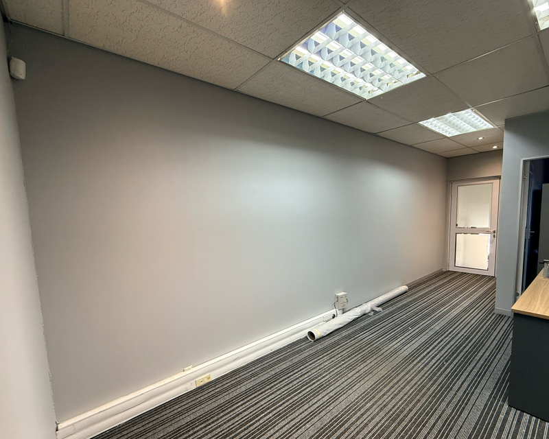 Office reception before the installation of a custom seamless wallpaper feature wall.